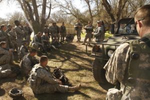 A military After Action Review being conducted in the field.