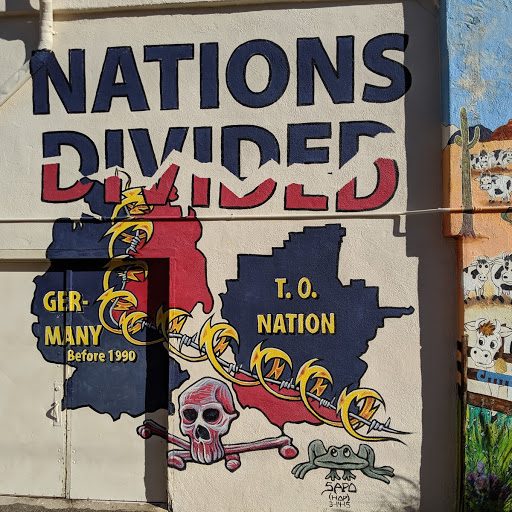 Mural comparing the state of the Tohono O'odham nation to Germany before 1990 in Ajo, Arizona.