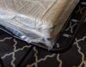 A corner of a sofa sleeper mattress illustrates how thin it is