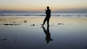Man practicing tai chi on a shore.