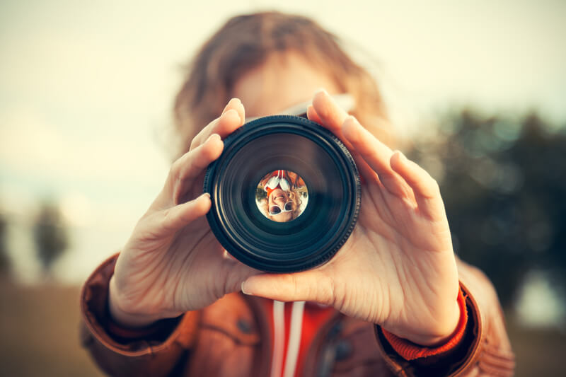 a person looking through a lens