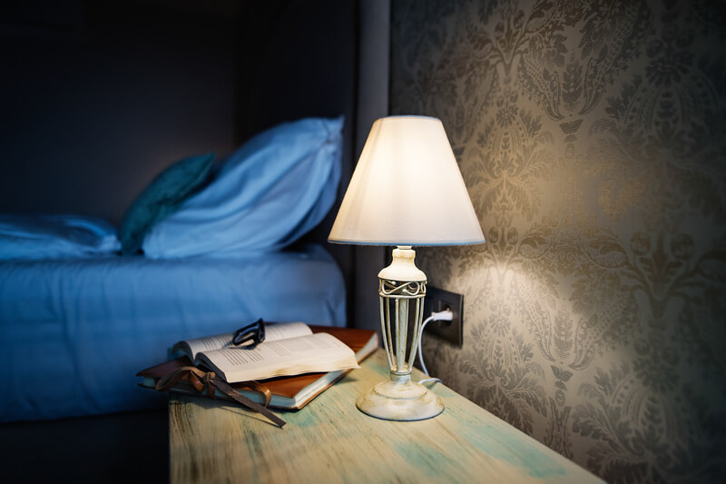 a bedside notebook and lamp