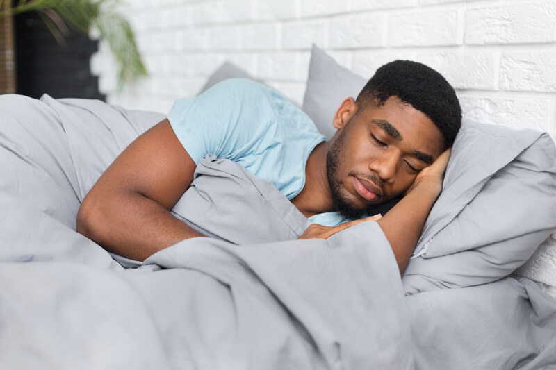 a sleeping man with his head on a pillow