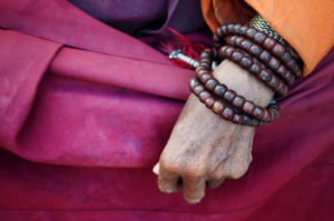 A Buddhist monk with prayer bracelets