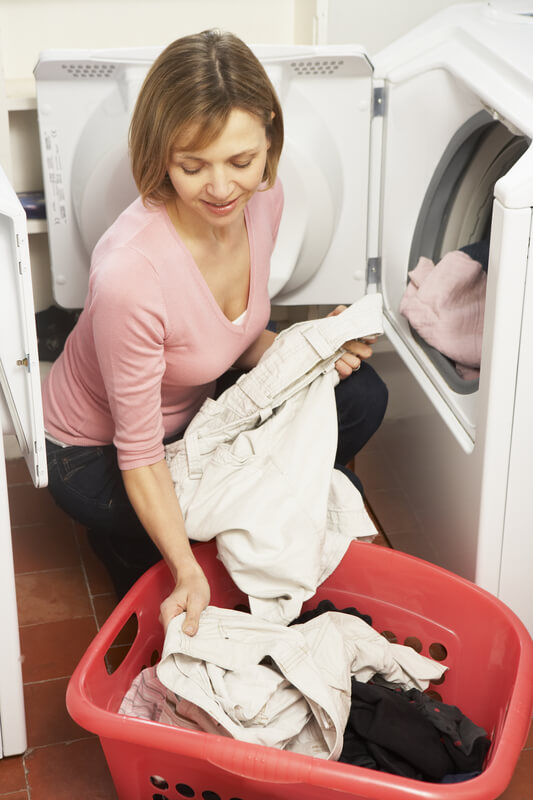 woman washing clothes in a washing machine