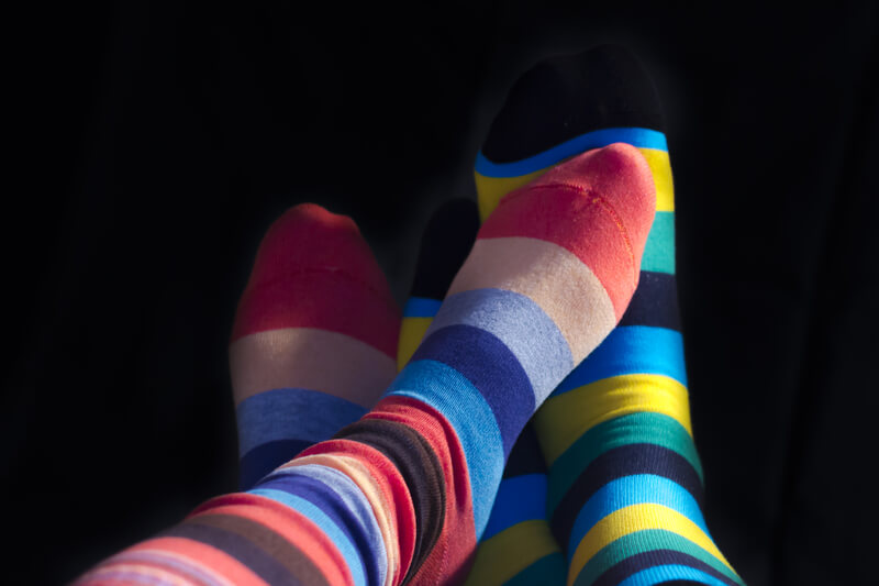 A couple wearing striped socks.