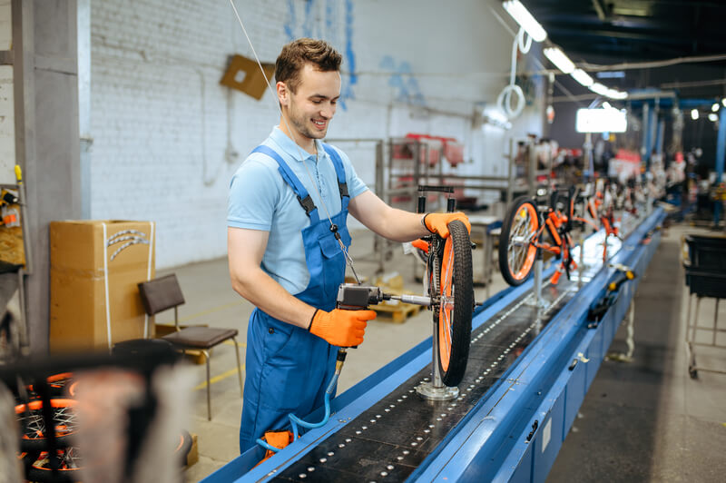 a worker in a bicycle factory
